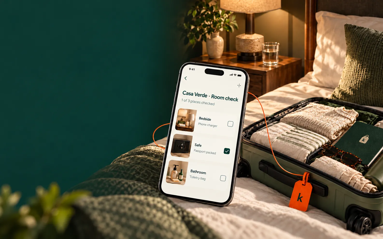 A room-check preview beside packed luggage in a hotel